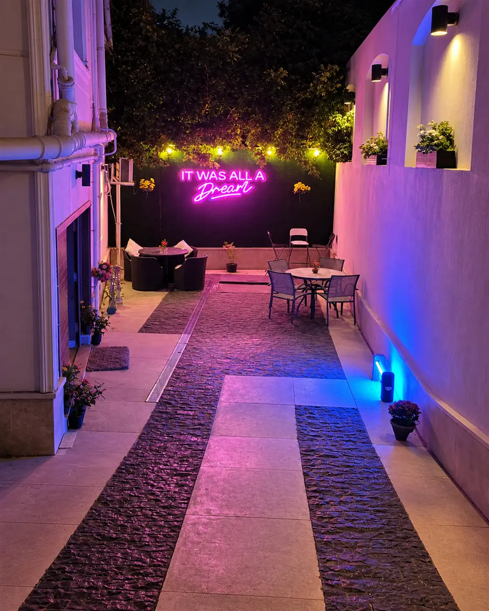 The lit walkway outside, with an It Was All A Dream neon sign
